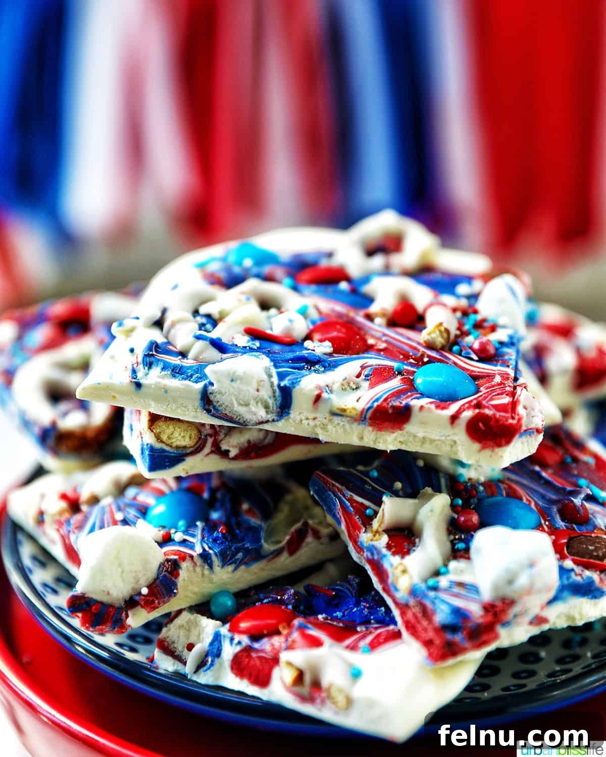 Fourth of July Freedom Bark 3 side view of a piece of red, white, and blue bark, highlighting its layered texture and colorful toppings.