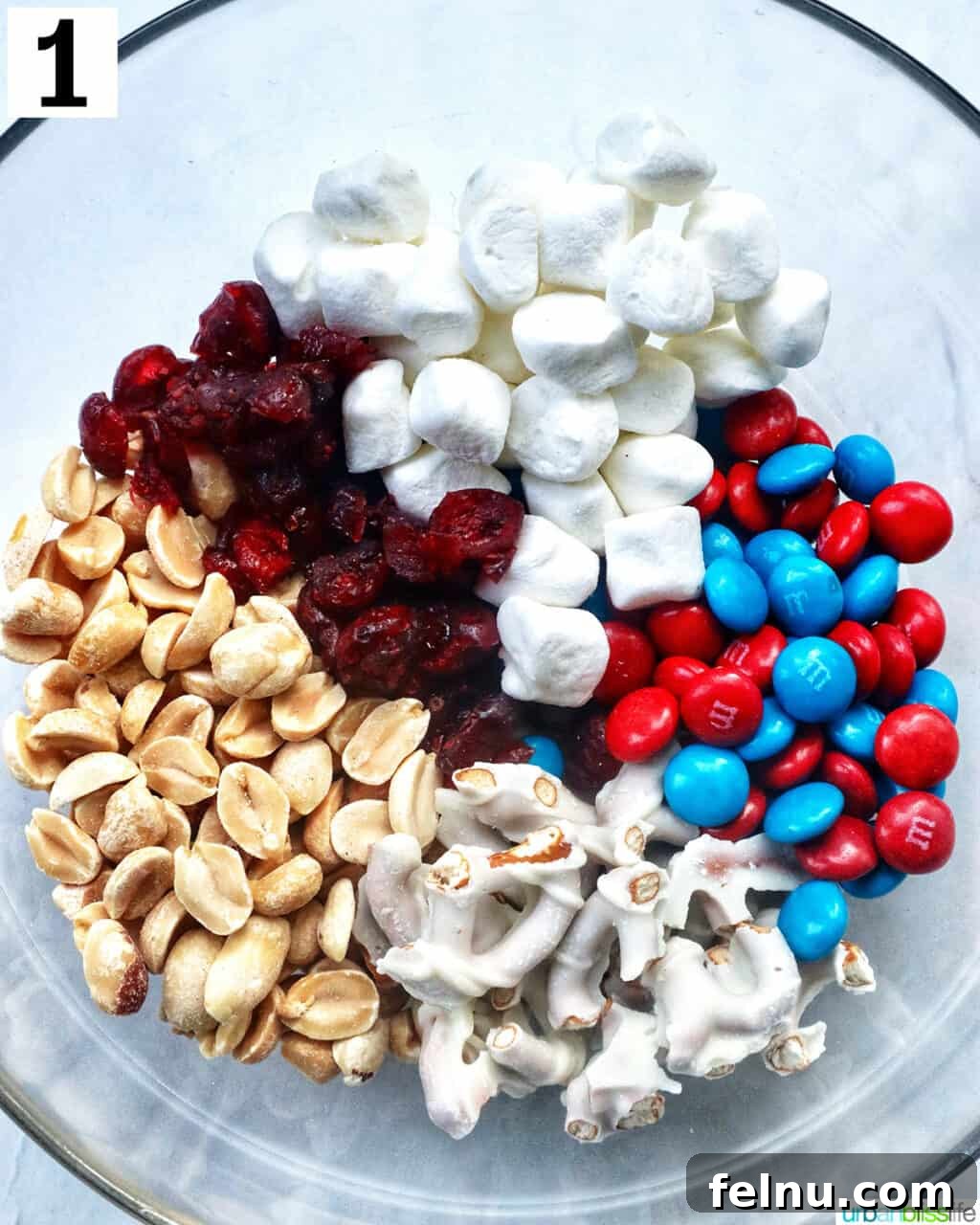 Stars and Stripes Snack Blend 5 A large bowl containing all the individual ingredients before mixing, showcasing vibrant colors.