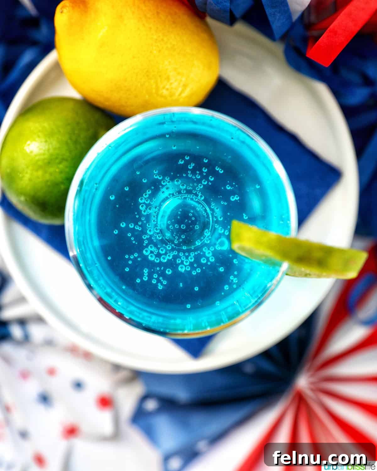 Overhead view of Blue Wave Cocktail with lime and lemon.