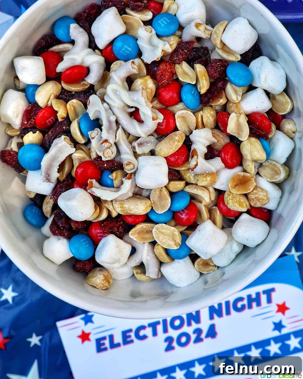 Ultimate Election Night Celebration Guide 5 bowl of red, white, and blue trail mix with Election Bingo card for 2024.