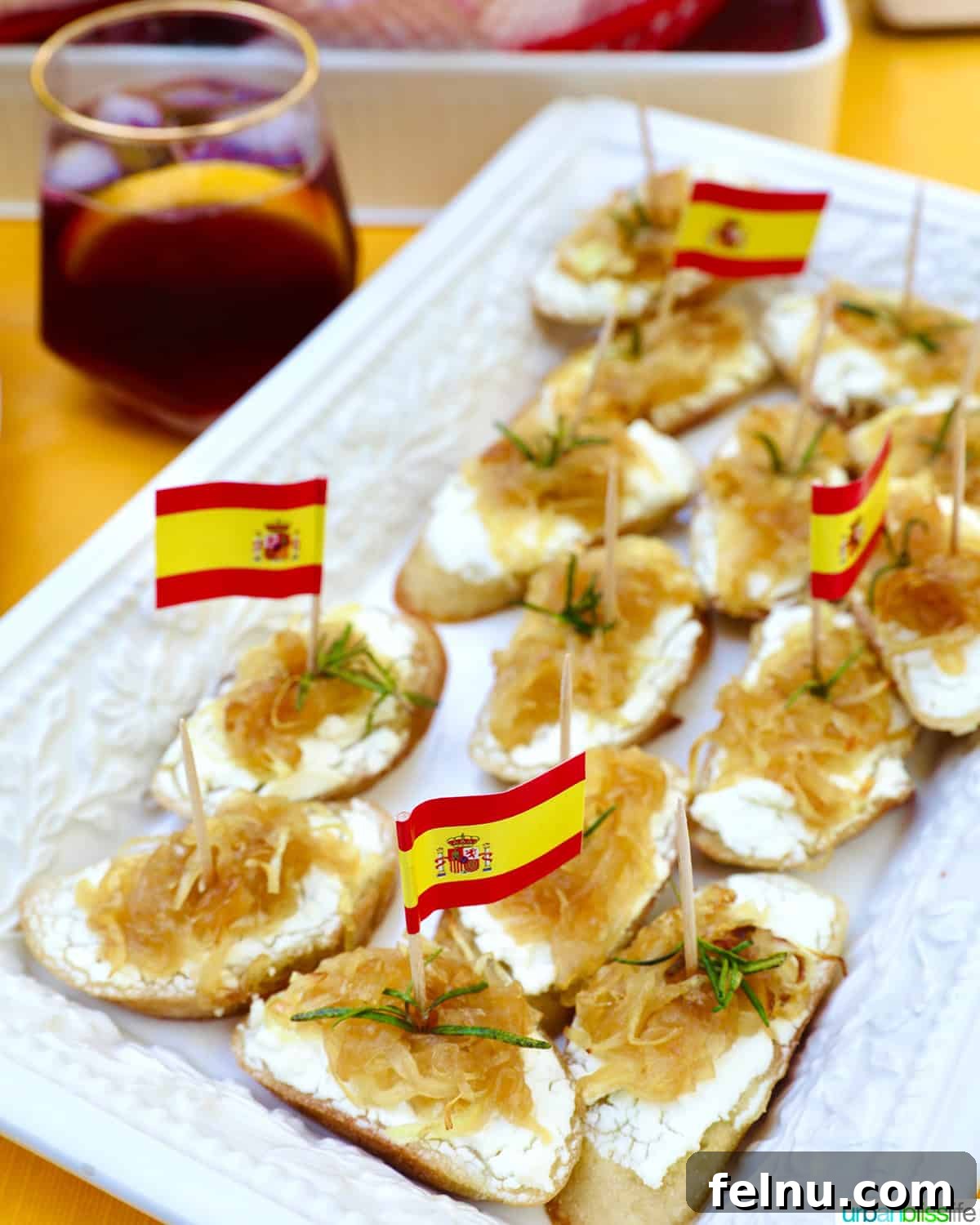 Golden Onion and Chevre Morsels 13 A close-up of a plate of caramelized onion and goat cheese crostini, ready to be paired with wine.