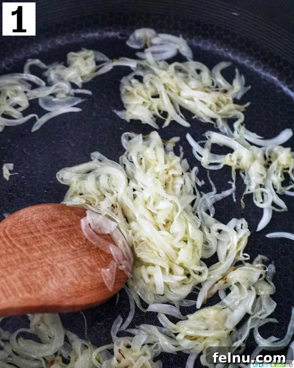 Golden Onion and Chevre Morsels 5 Thinly sliced onions sautéing in a large non-stick skillet with a wooden spoon.