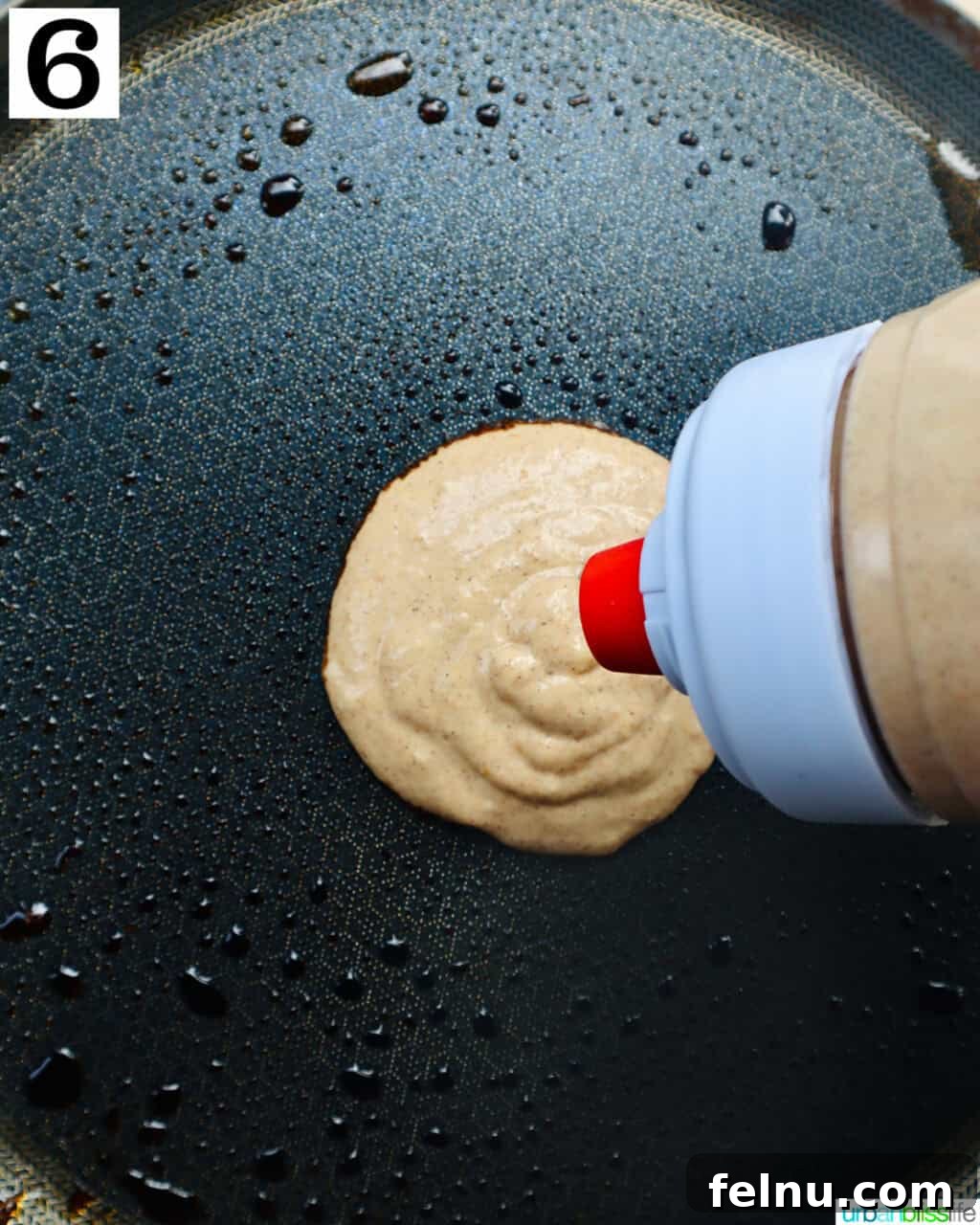 Pouring pancake batter onto the hot griddle.