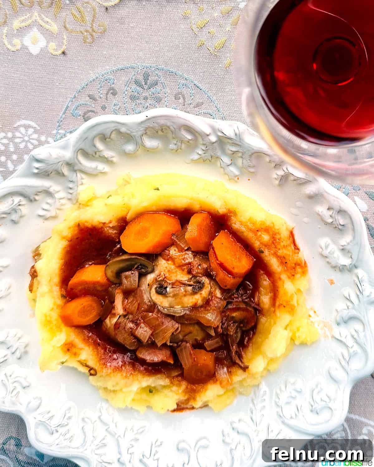 Iconic French Culinary Delights 11 A rustic bowl brimming with Coq au Vin, showcasing tender chicken pieces, mushrooms, and bacon in a rich, red wine sauce.