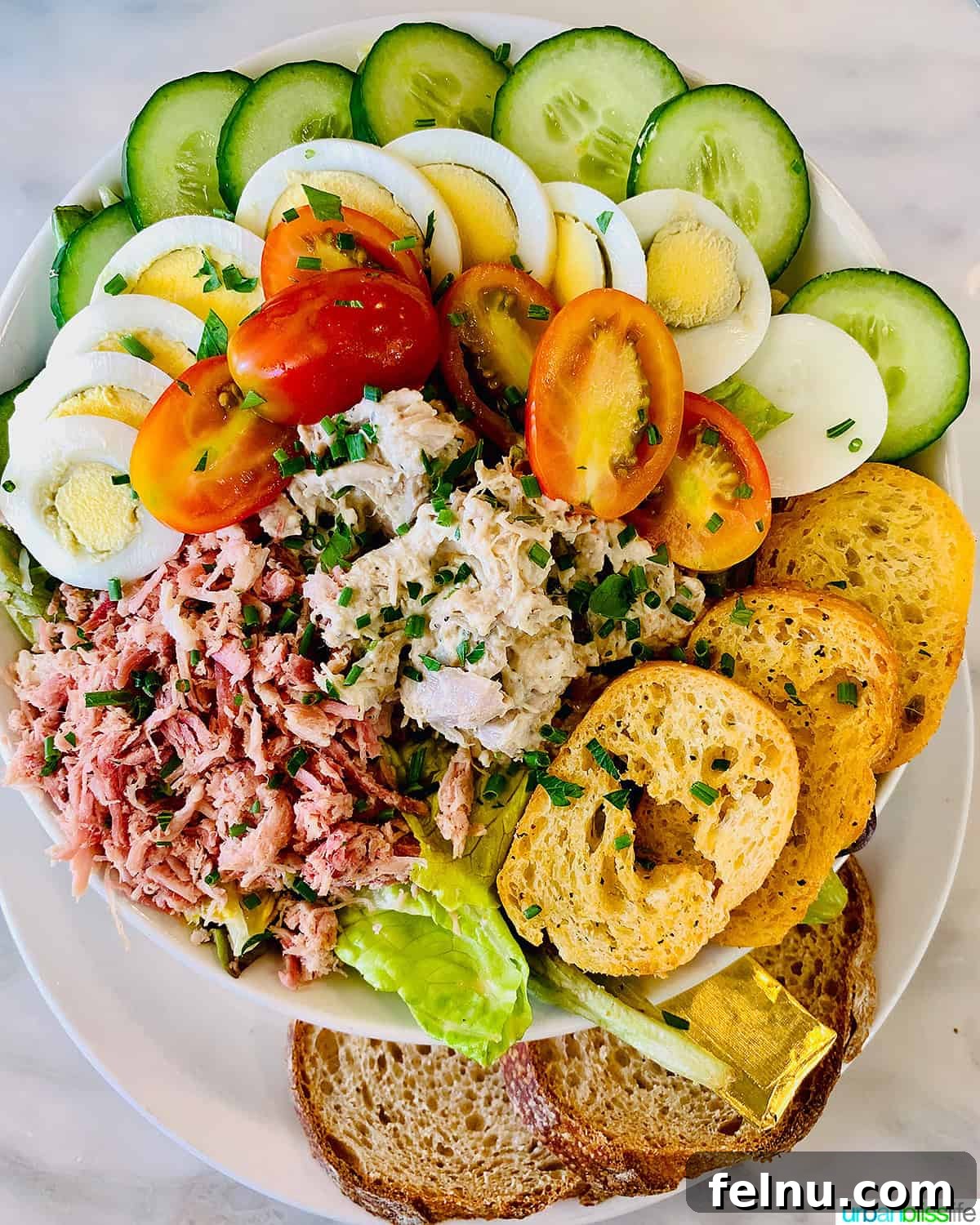 Iconic French Culinary Delights 12 A beautifully composed bowl of Tuna Niçoise salad, featuring fresh greens, tuna, eggs, olives, and vegetables, showcasing its colorful and healthy appeal.