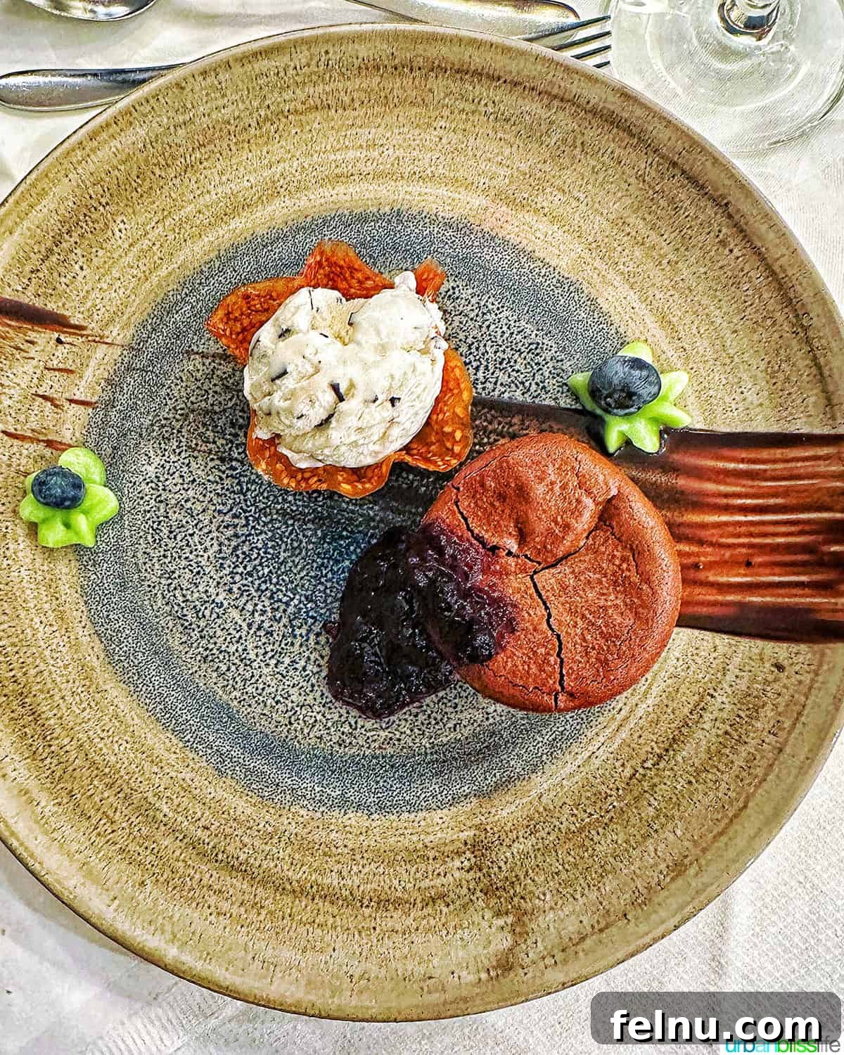 Iconic French Culinary Delights 18 An elegantly presented plate of chocolate soufflé, perfectly puffed and dusted with cocoa, embodying delicate French dessert artistry.