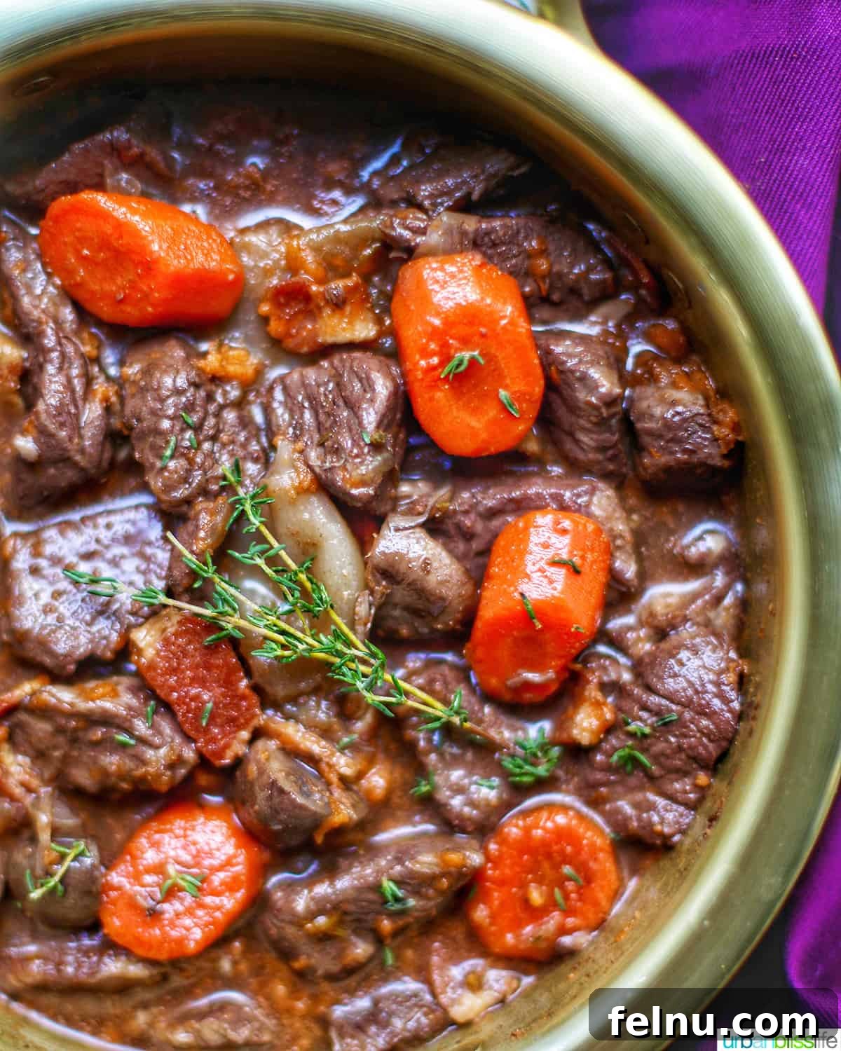 Iconic French Culinary Delights 4 Close-up of a rich, hearty beef bourguignon stew, garnished with fresh thyme in a large rustic bowl, emphasizing its comforting appeal.