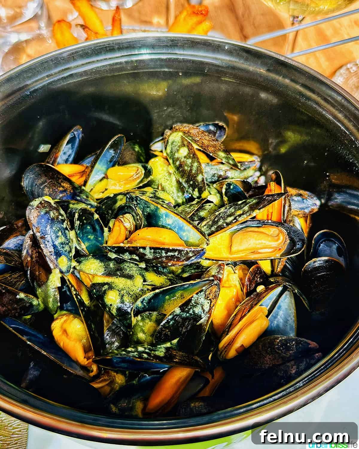 Iconic French Culinary Delights 8 A steaming bowl of fresh mussels, prepared in a classic Moules Marinières style, inviting seafood lovers to indulge.