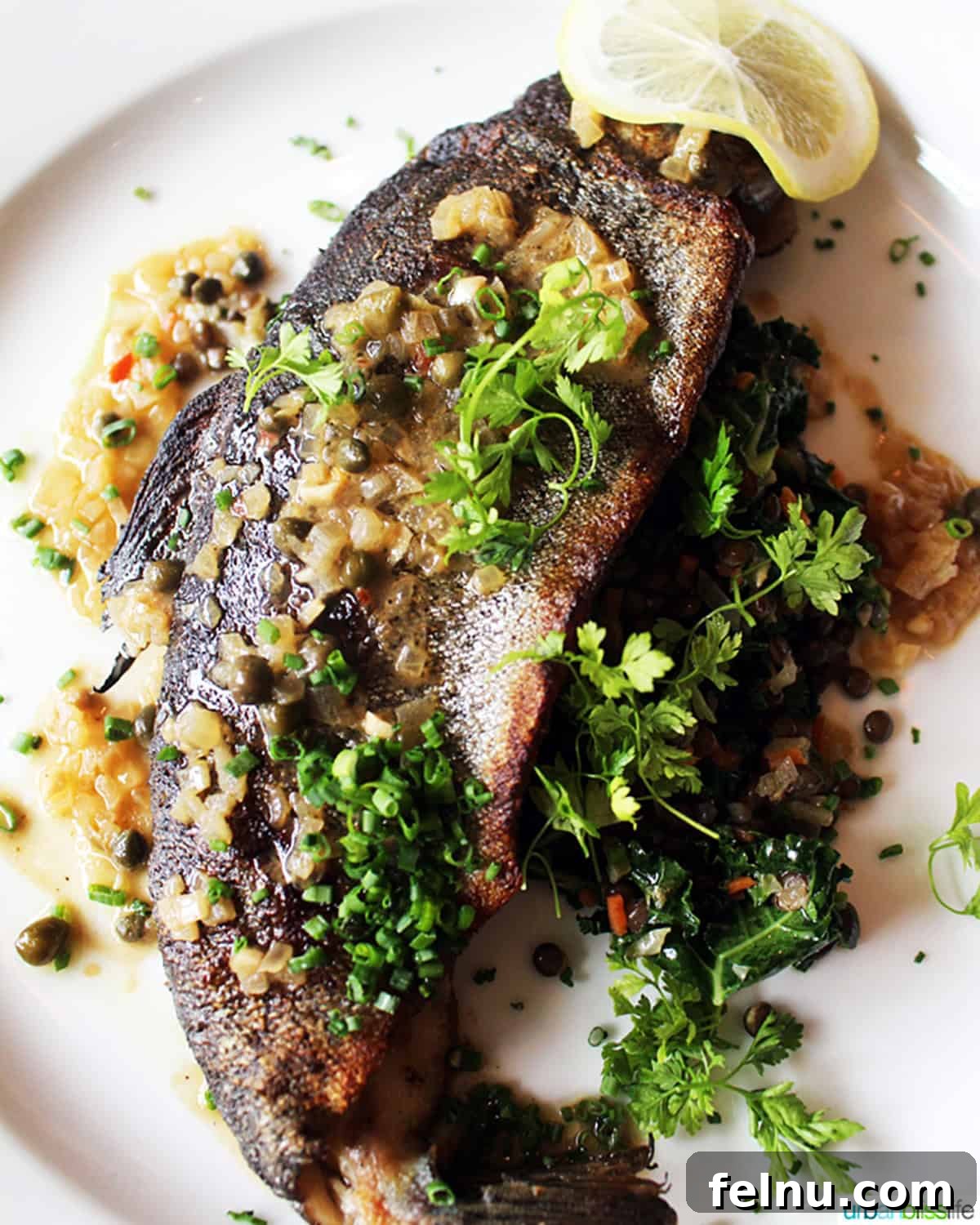 Iconic French Culinary Delights 9 A delicate trout meuniere fillet presented elegantly on a white plate, garnished with fresh parsley and a lemon wedge.