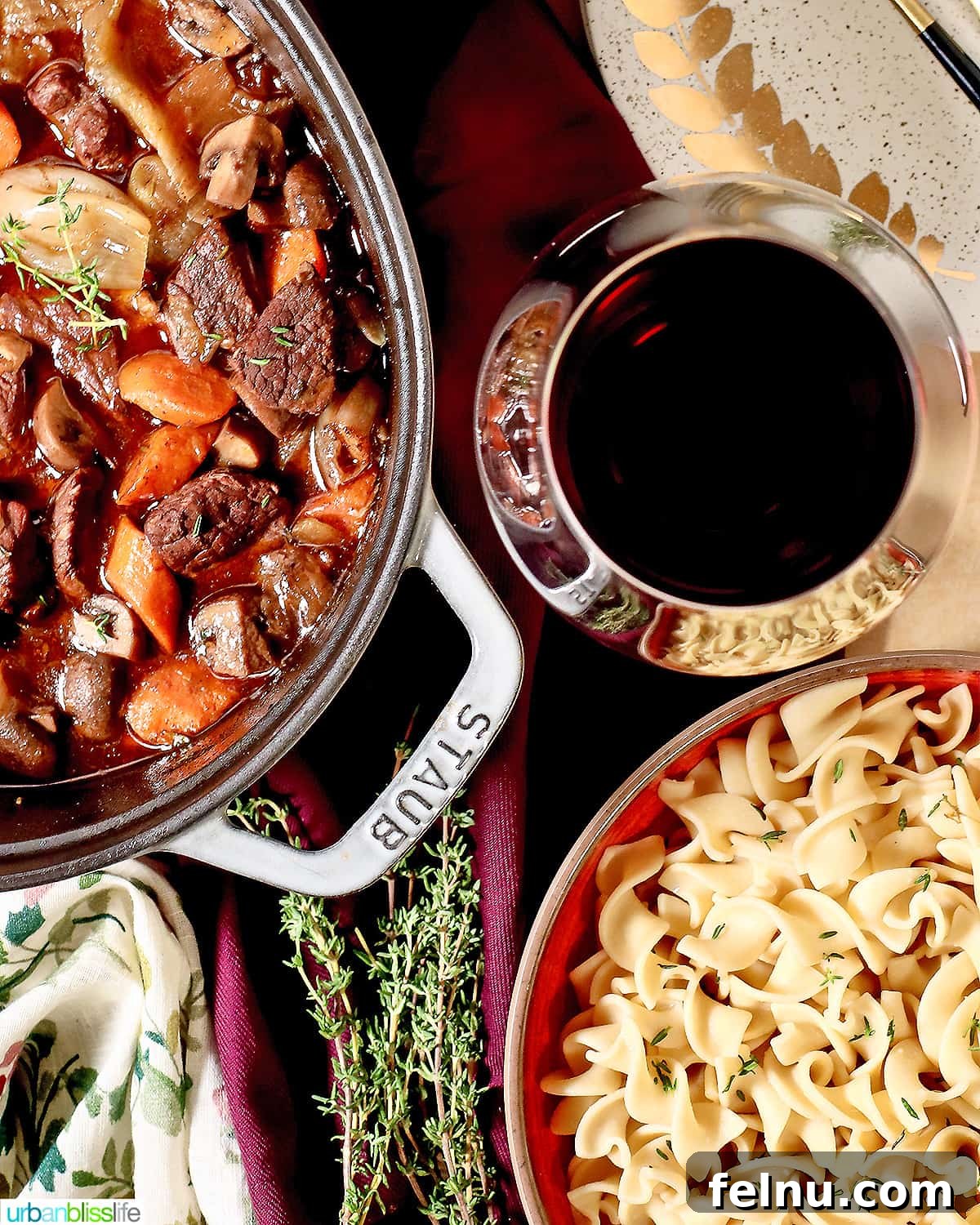 Pairing Perfection: Sides for Beef Stew 5 A cozy scene featuring a Dutch oven of beef bourguignon, a glass of red wine, and a side of pasta.