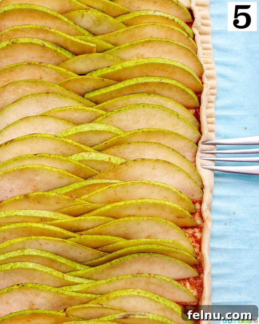 Image showing the border of the puff pastry being folded up and crimped.