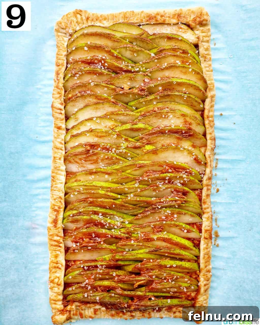 Image showing the finished pear tart, baked and golden brown.