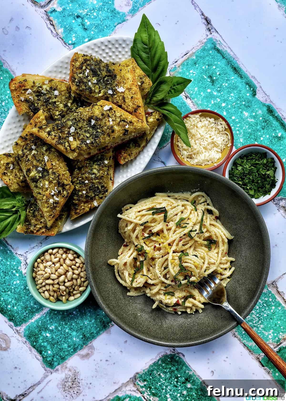 Tahini Sweet Treat 15 Tahini pasta served with pesto bread and various side dishes.