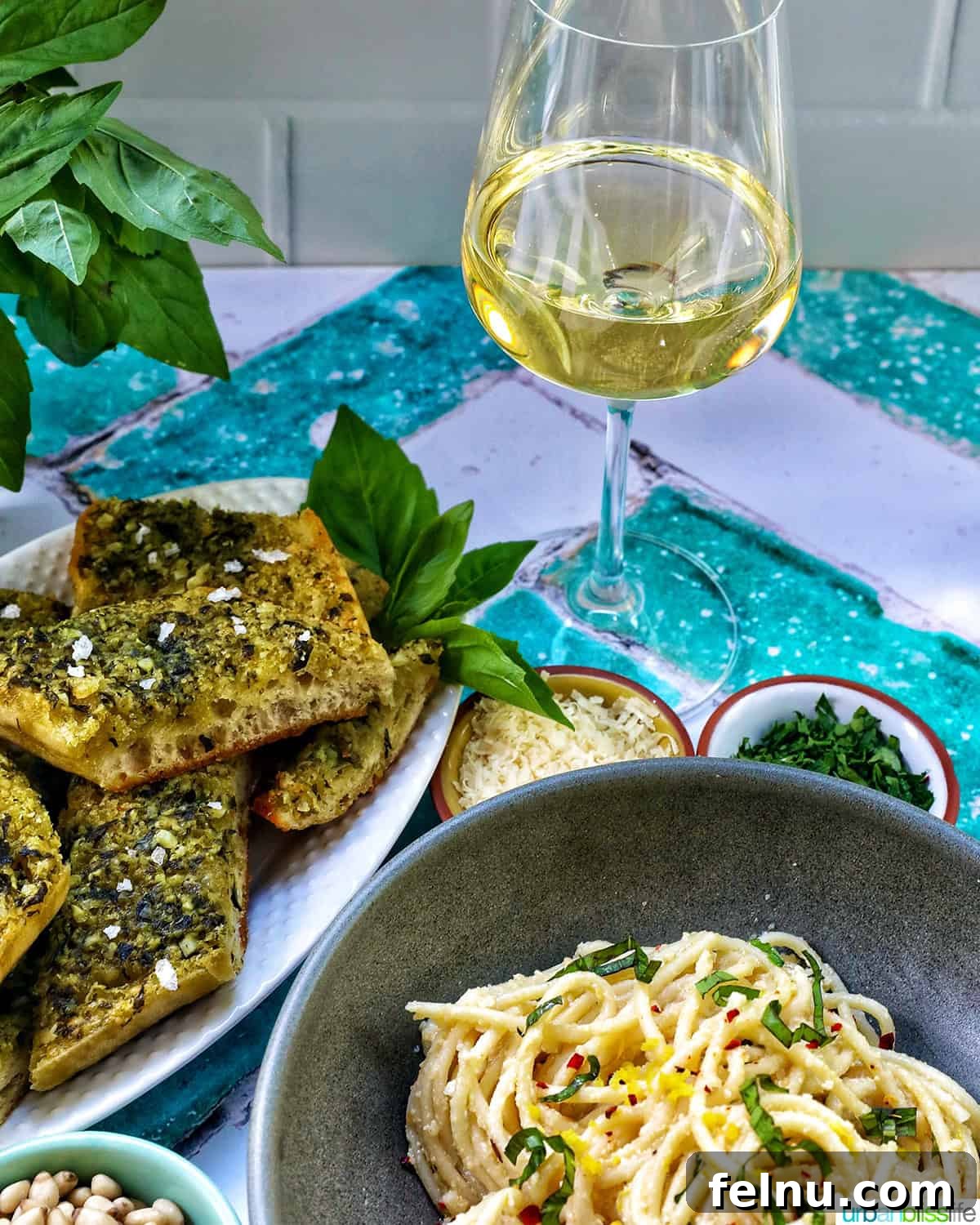 Tahini Sweet Treat 16 Tahini pasta with a glass of white wine and side dishes.