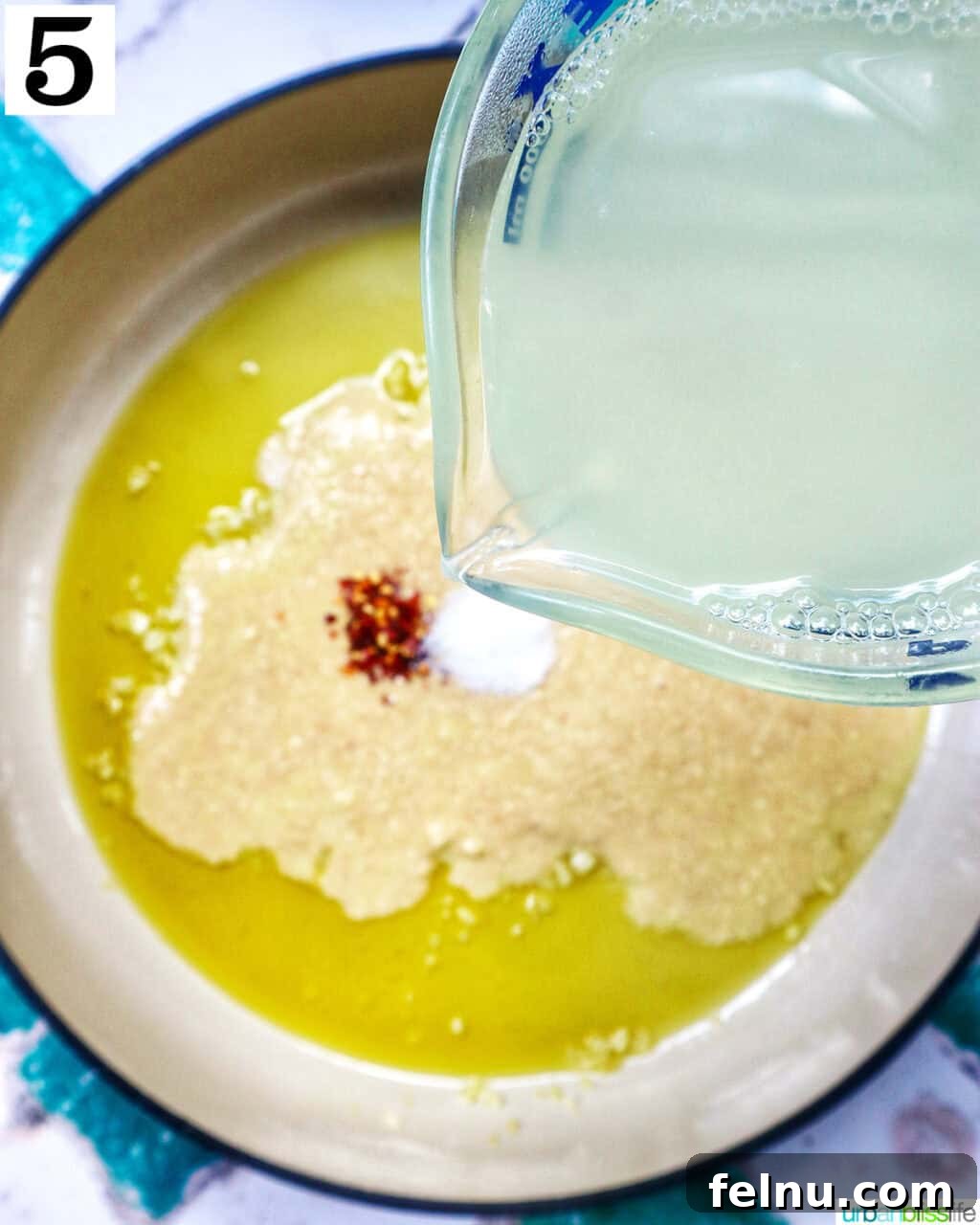 Tahini Sweet Treat 10 Adding lemon juice to spices, garlic, and olive oil in a saucepan.