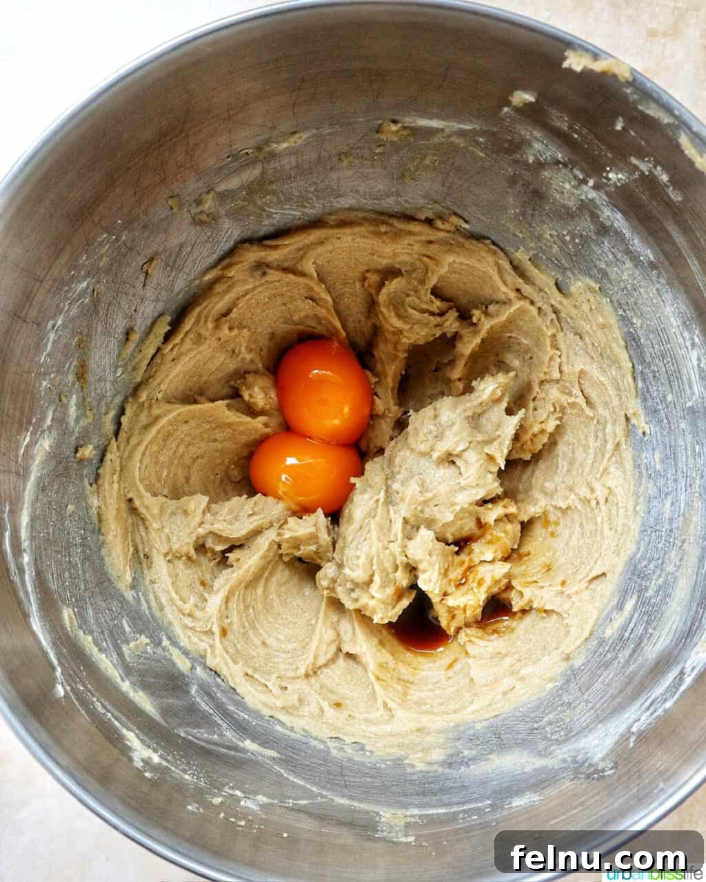 pumpkin pie spice batter in a stand mixer bowl.