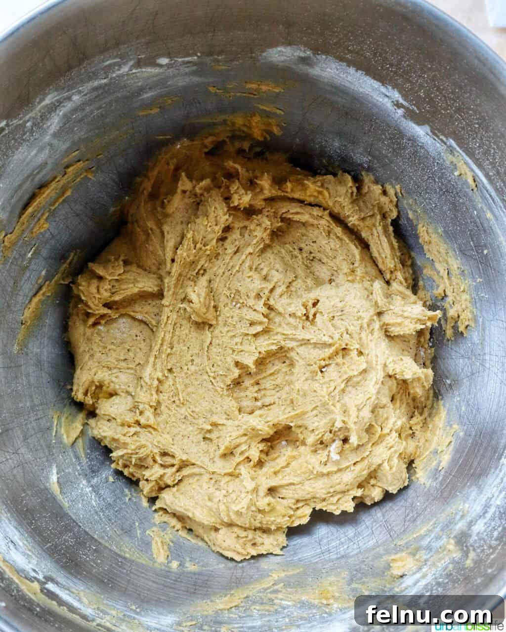 pumpkin pie spice batter in a stand mixer bowl.