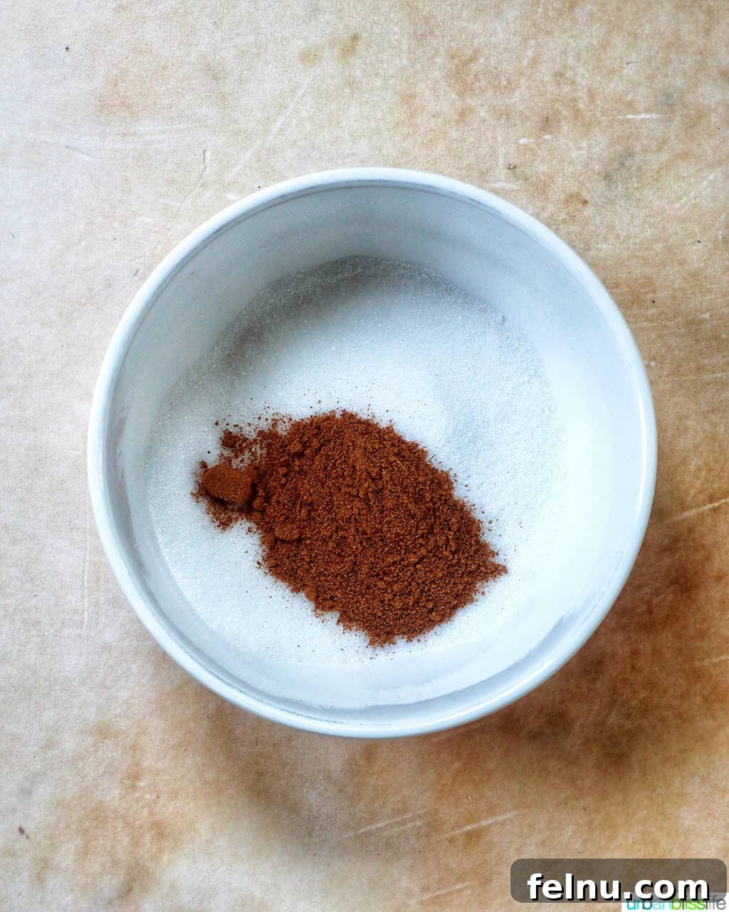 ground cinnamon and granulated sugar in a white bowl.