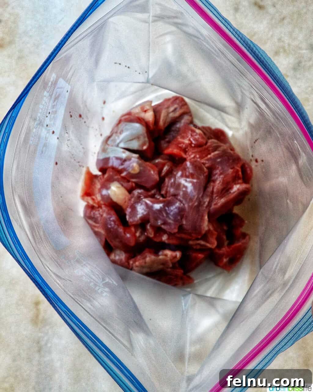 Slow Cooker Massaman Beef Curry 5 Beef cubes in a ziploc bag, ready to be coated with flour for the slow cooker beef massaman curry recipe.