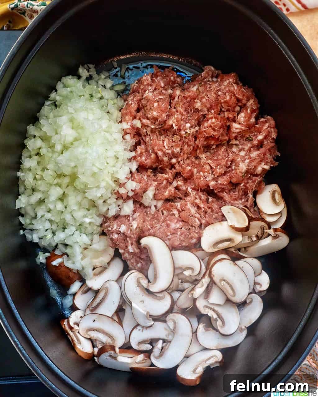 Smoky Sausage Pumpkin Bisque 5 Diced onions, sliced mushrooms, and ground sausage sizzling together in a sturdy Dutch oven, beginning the aromatic base of the soup.