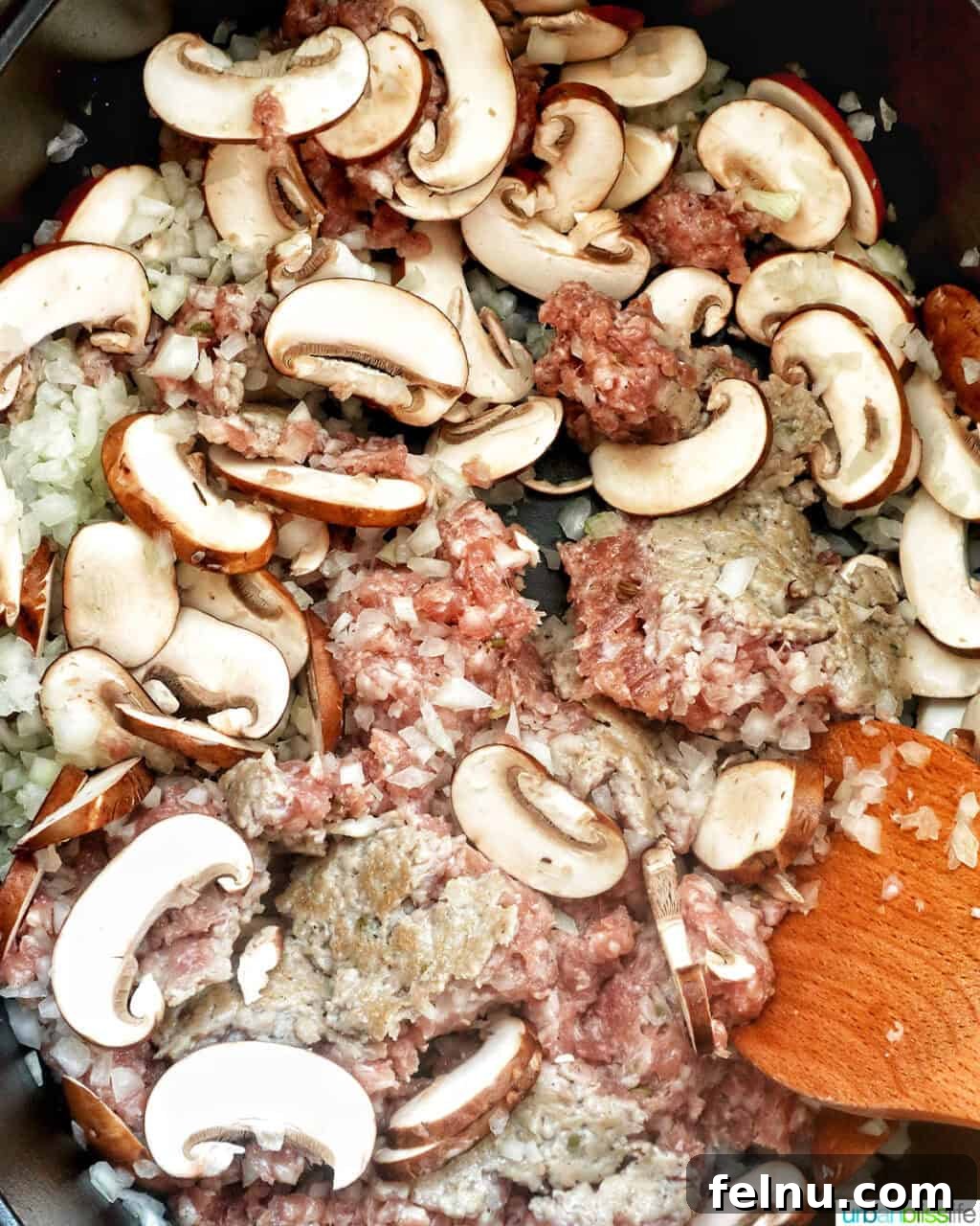 Smoky Sausage Pumpkin Bisque 6 A close-up view of mushrooms and sausage browning in a Dutch oven, releasing their savory aromas and developing rich flavors.