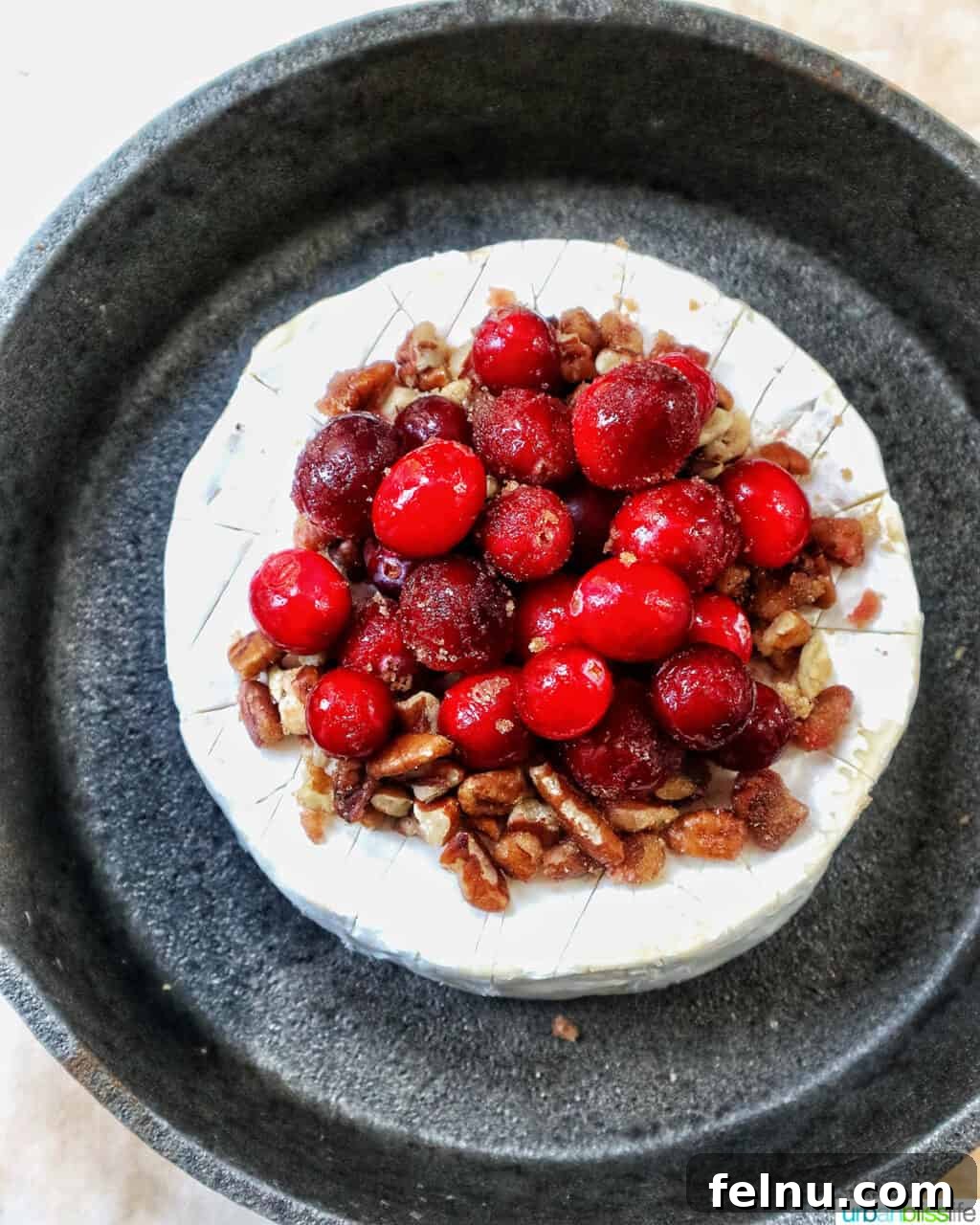 Cranberry and Pecan Crusted Brie 8 Overhead view of Cranberry Pecan Baked Brie in a skillet.