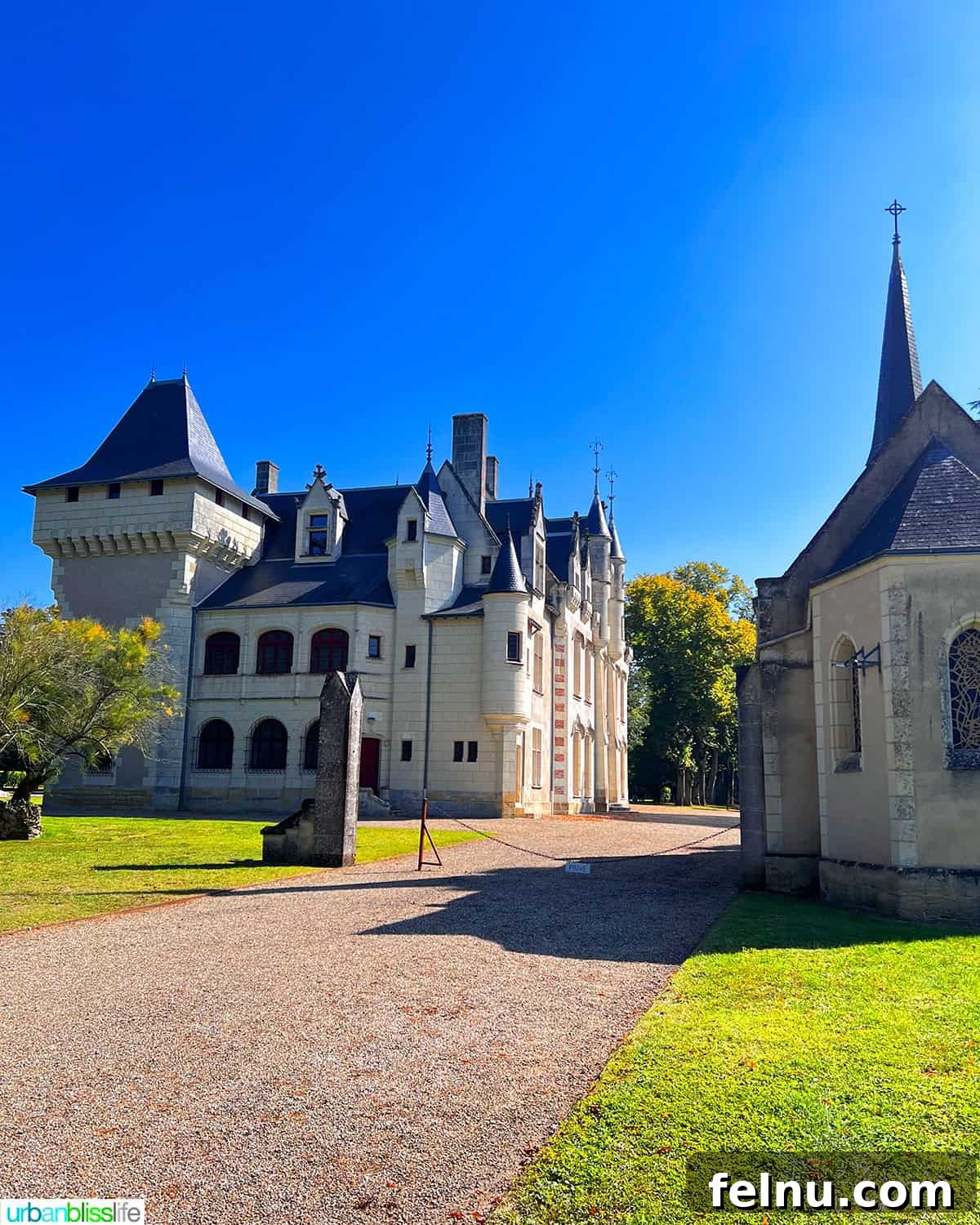 Uncorking the Elegance of Chateau de la Grille 2 Château de la Grille: a historic Loire Valley castle with a charming chapel, surrounded by vibrant vineyards under a clear sky.