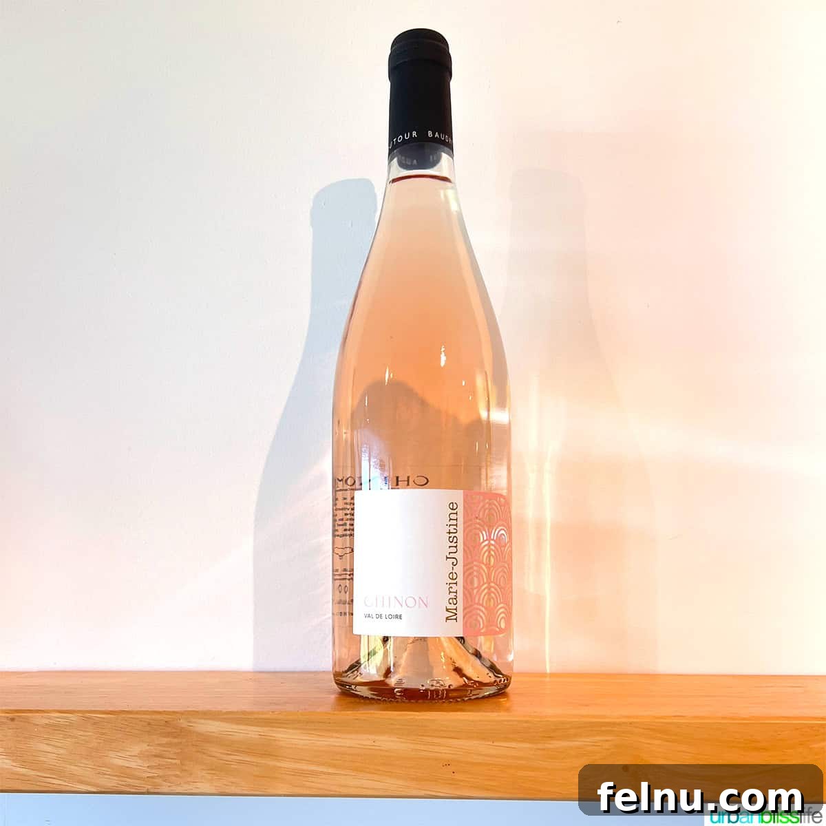 Uncorking the Elegance of Chateau de la Grille 6 A bottle of Château de la Grille's Marie-Justine Rosé, showcasing its beautiful salmon color, ready to be enjoyed on a warm day.