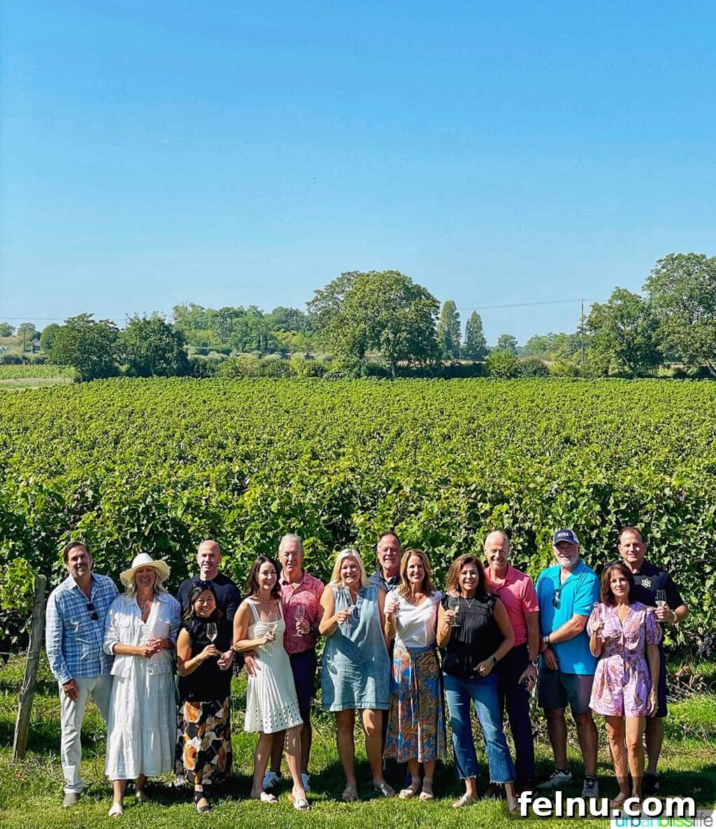 Uncorking the Elegance of Chateau de la Grille 9 A group enjoying a relaxed wine tasting experience directly within the beautiful vineyards of Château de la Grille in Chinon, France, under a clear sky.