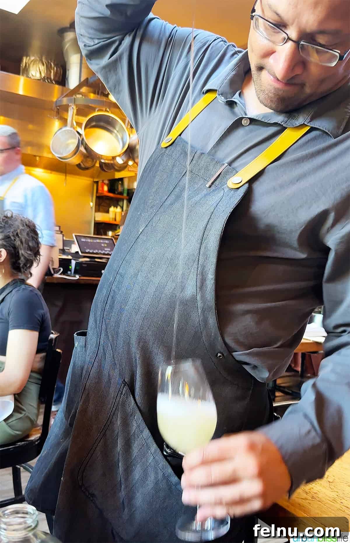 Txakoli Wine Explained: Basque Country's Unique Sip 3 waiter at Urdaneta restaurant in Portland pouring Txakoli wine