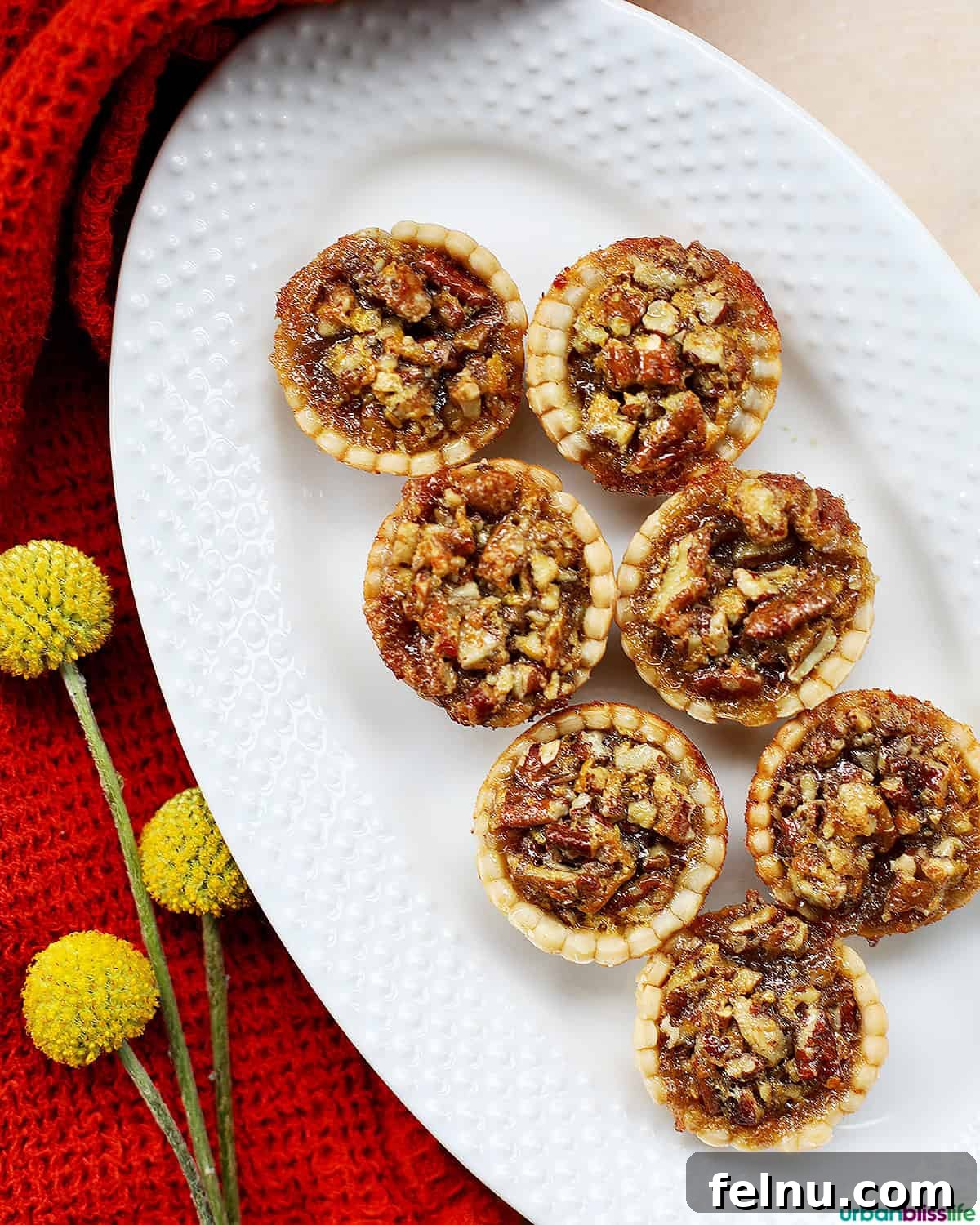 Mini Pecan Tarts 2 Mini pecan pies beautifully arranged on a serving platter.