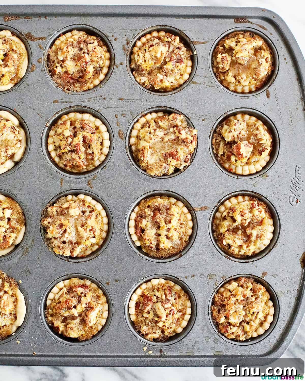 Mini Pecan Tarts 13 Mini pecan pies in a baking pan.