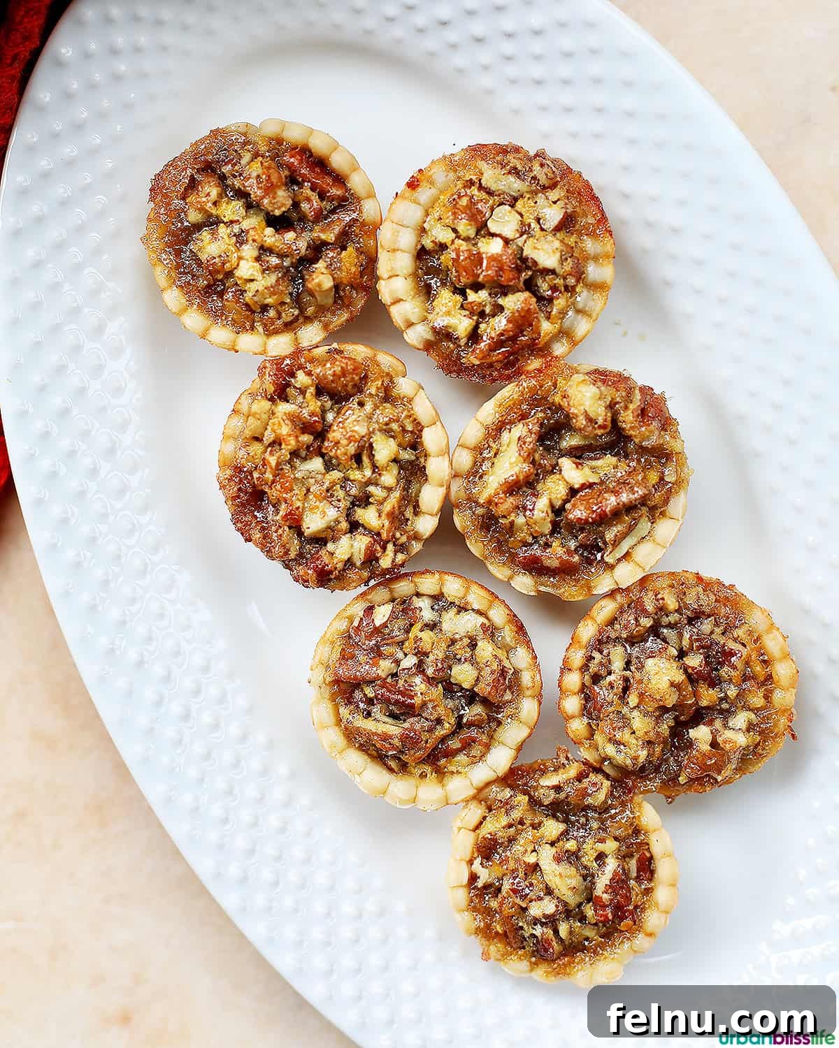Mini Pecan Tarts 4 Mini pecan pies on a serving platter.