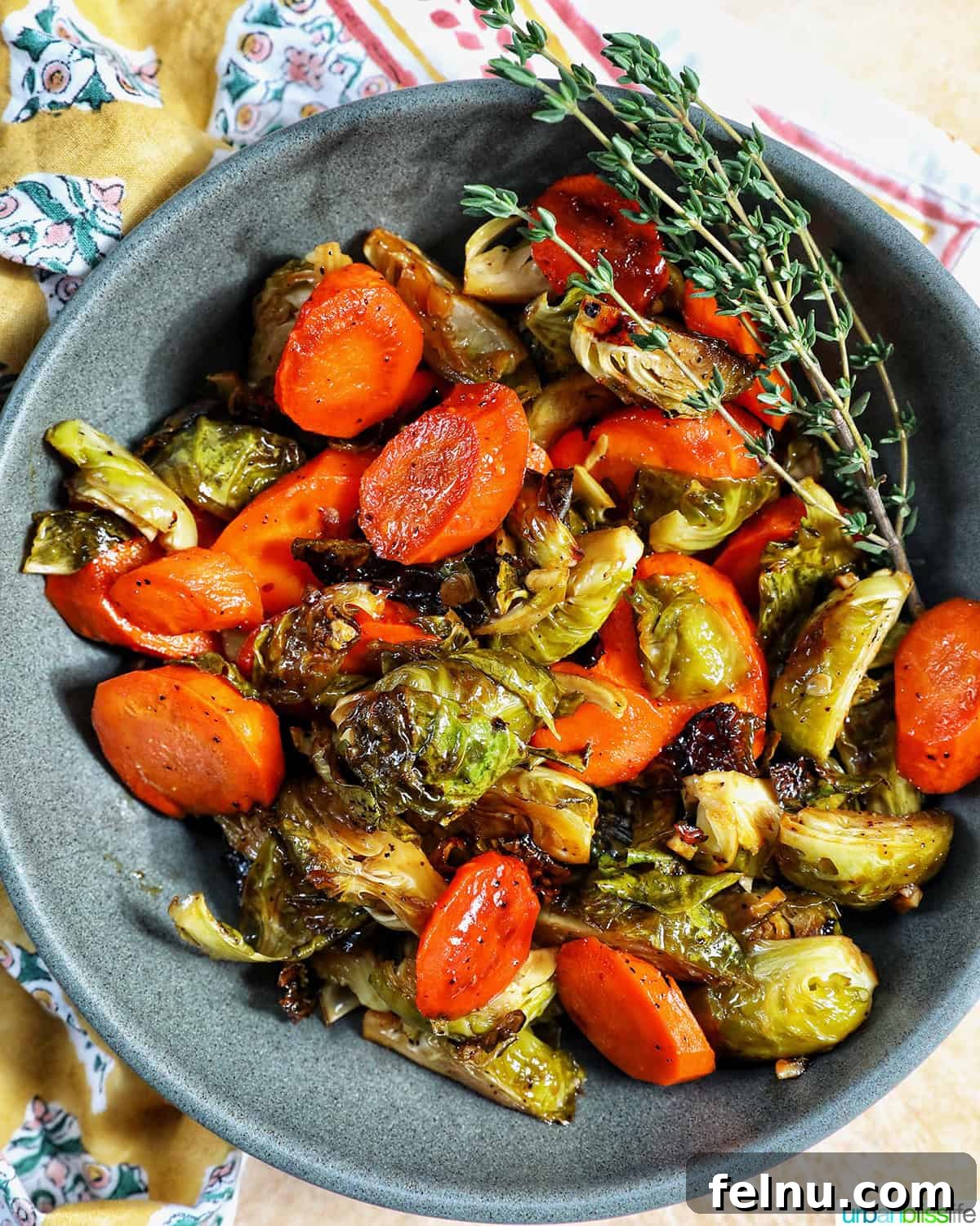 Roasted Brussels Sprouts with Maple-Glazed Carrots 3 Close-up of perfectly roasted Brussels sprouts and carrot slices in a serving bowl.