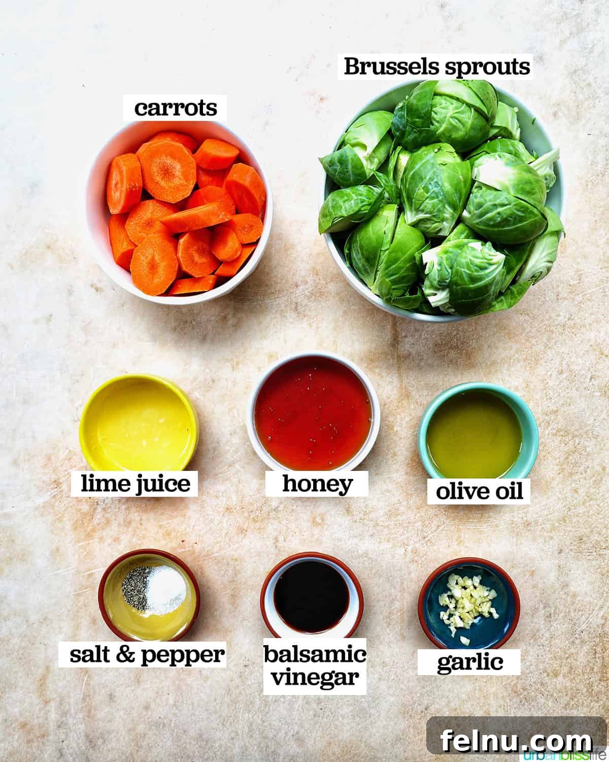 Roasted Brussels Sprouts with Maple-Glazed Carrots 4 Ingredients for roasted brussels sprouts and carrots displayed in separate bowls.