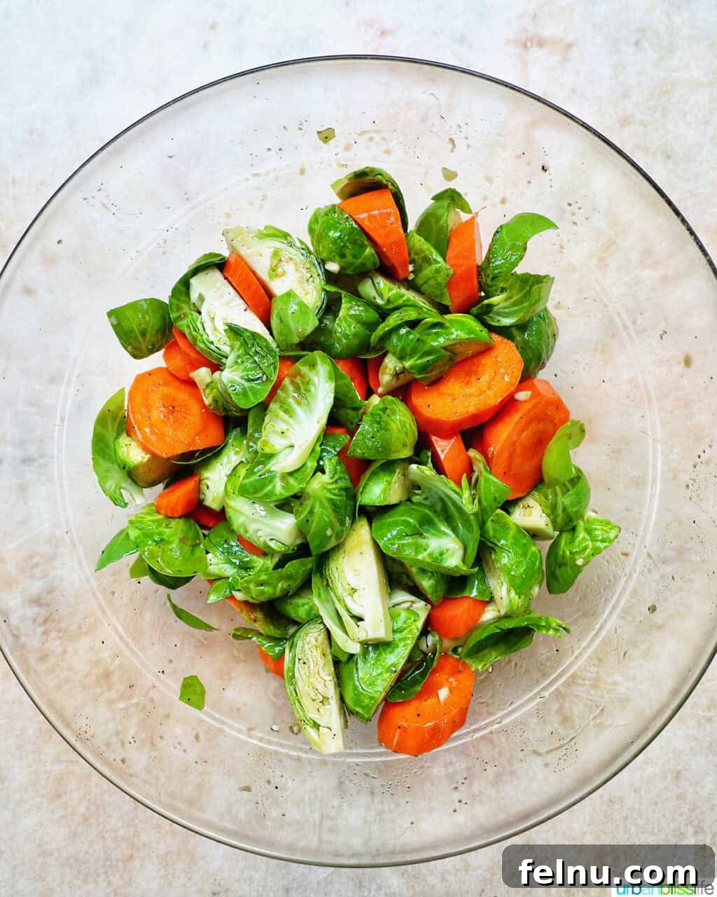 Roasted Brussels Sprouts with Maple-Glazed Carrots 6 Brussels sprouts and carrots tossed together in a large bowl.