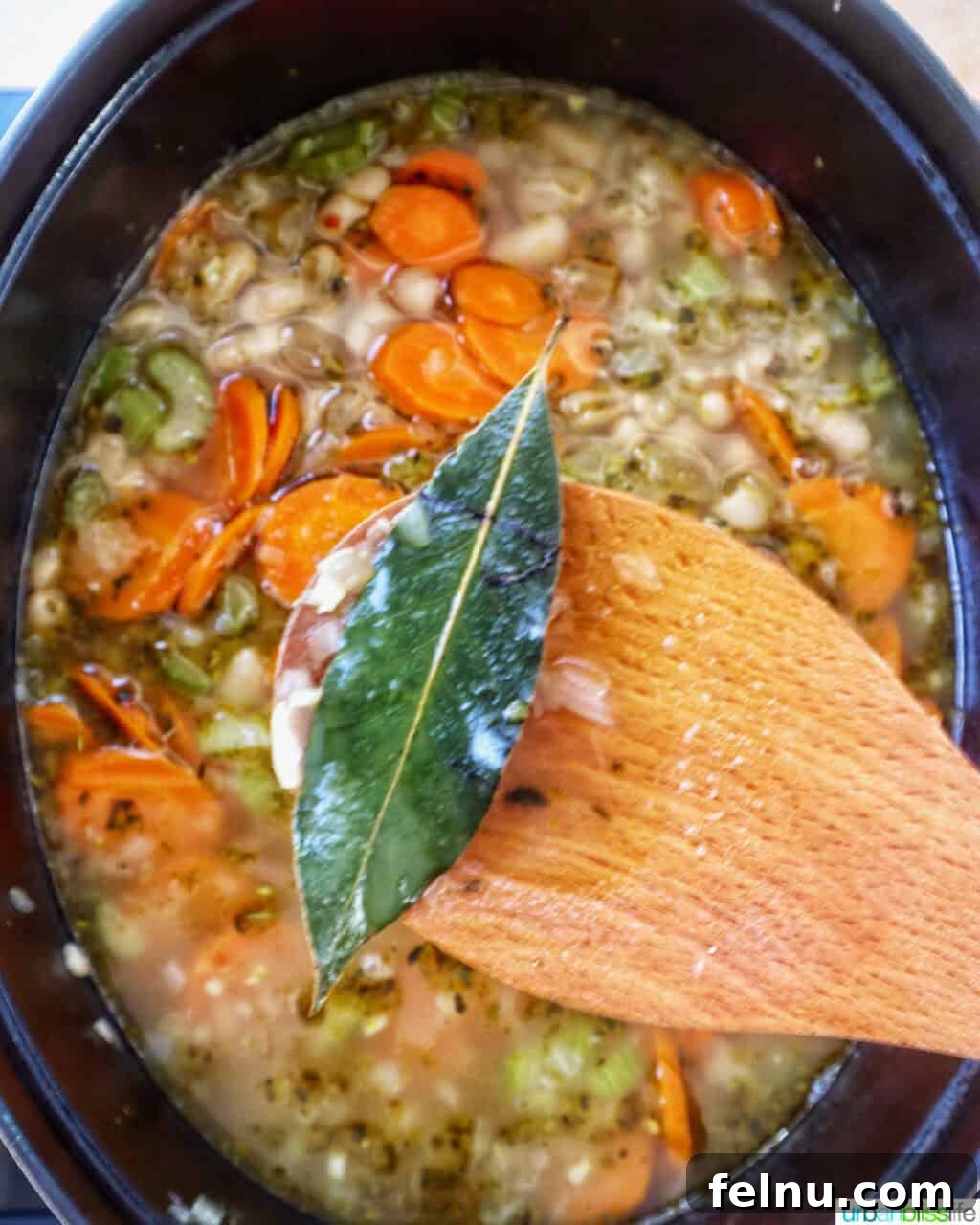 Tuscan Kale and White Bean Soup: A Hearty Italian Classic 13 Removing bay leaves from the soup