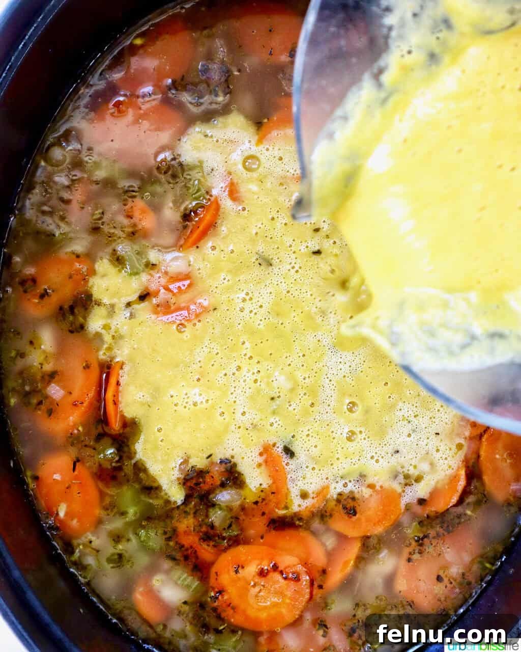 Tuscan Kale and White Bean Soup: A Hearty Italian Classic 17 Pouring blended soup back into the Dutch oven