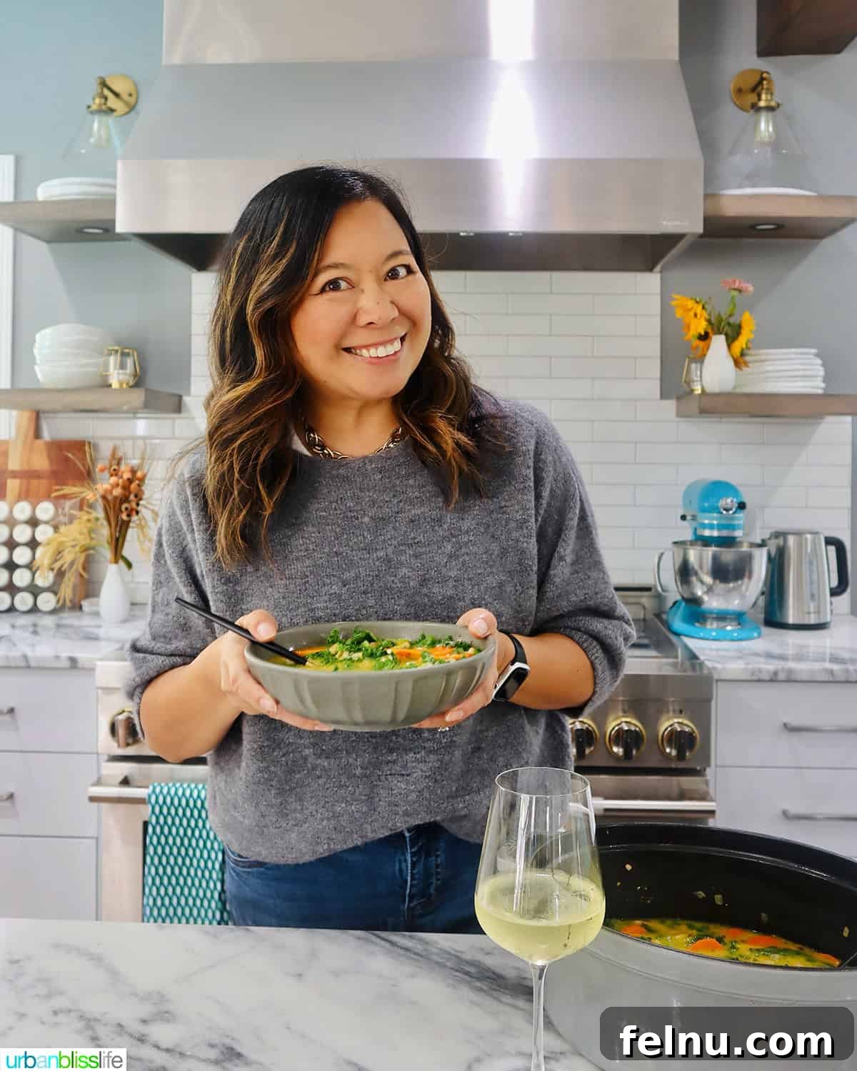 Tuscan Kale and White Bean Soup: A Hearty Italian Classic 21 Marlynn Schotland holding a bowl of Tuscan kale and white bean soup