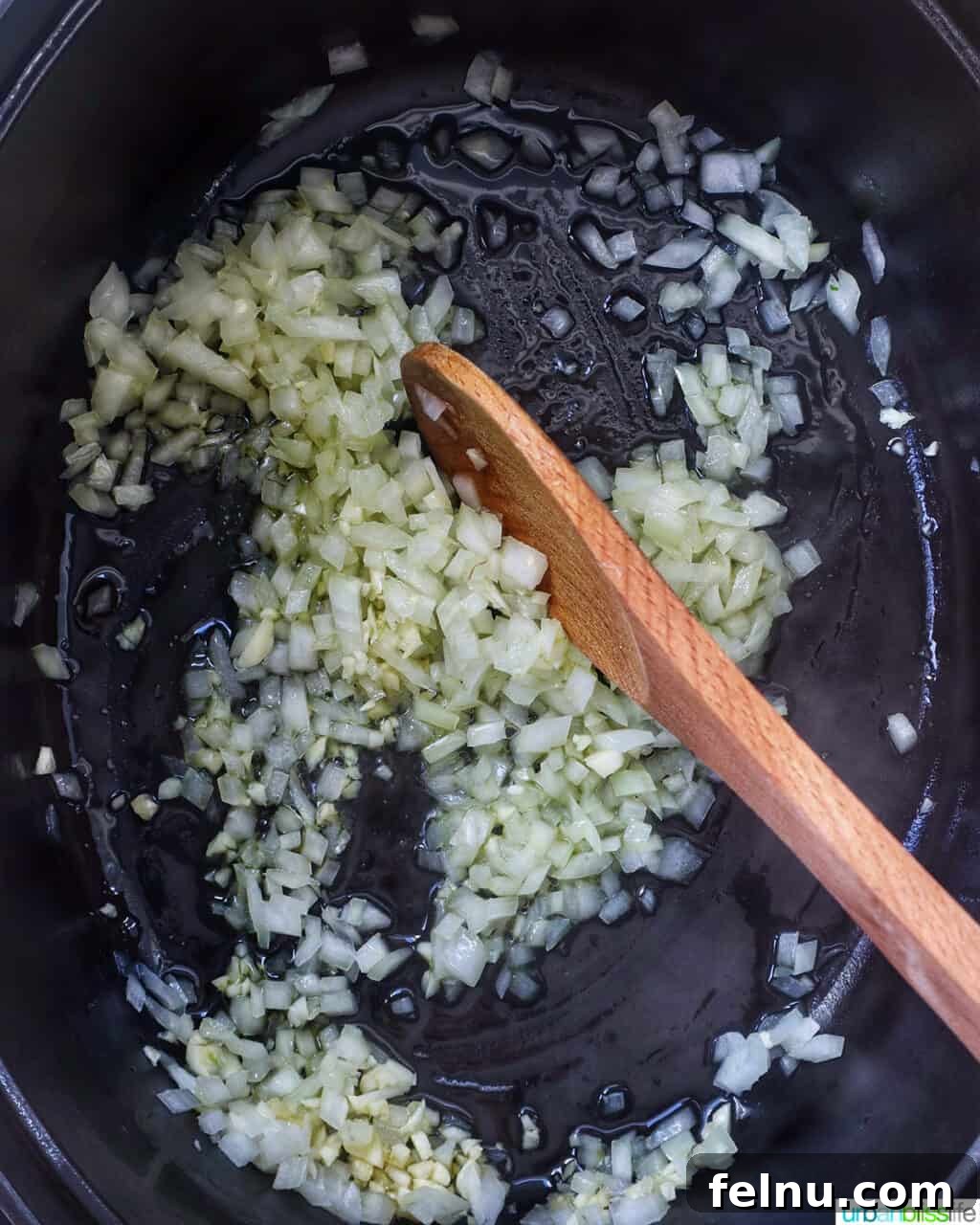 Tuscan Kale and White Bean Soup: A Hearty Italian Classic 7 Stirring onions and garlic in a Dutch oven