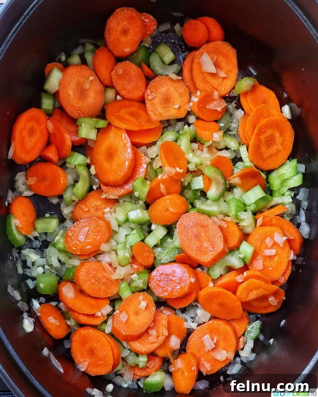 Tuscan Kale and White Bean Soup: A Hearty Italian Classic 8 Carrots and celery added to onions and garlic in a Dutch oven