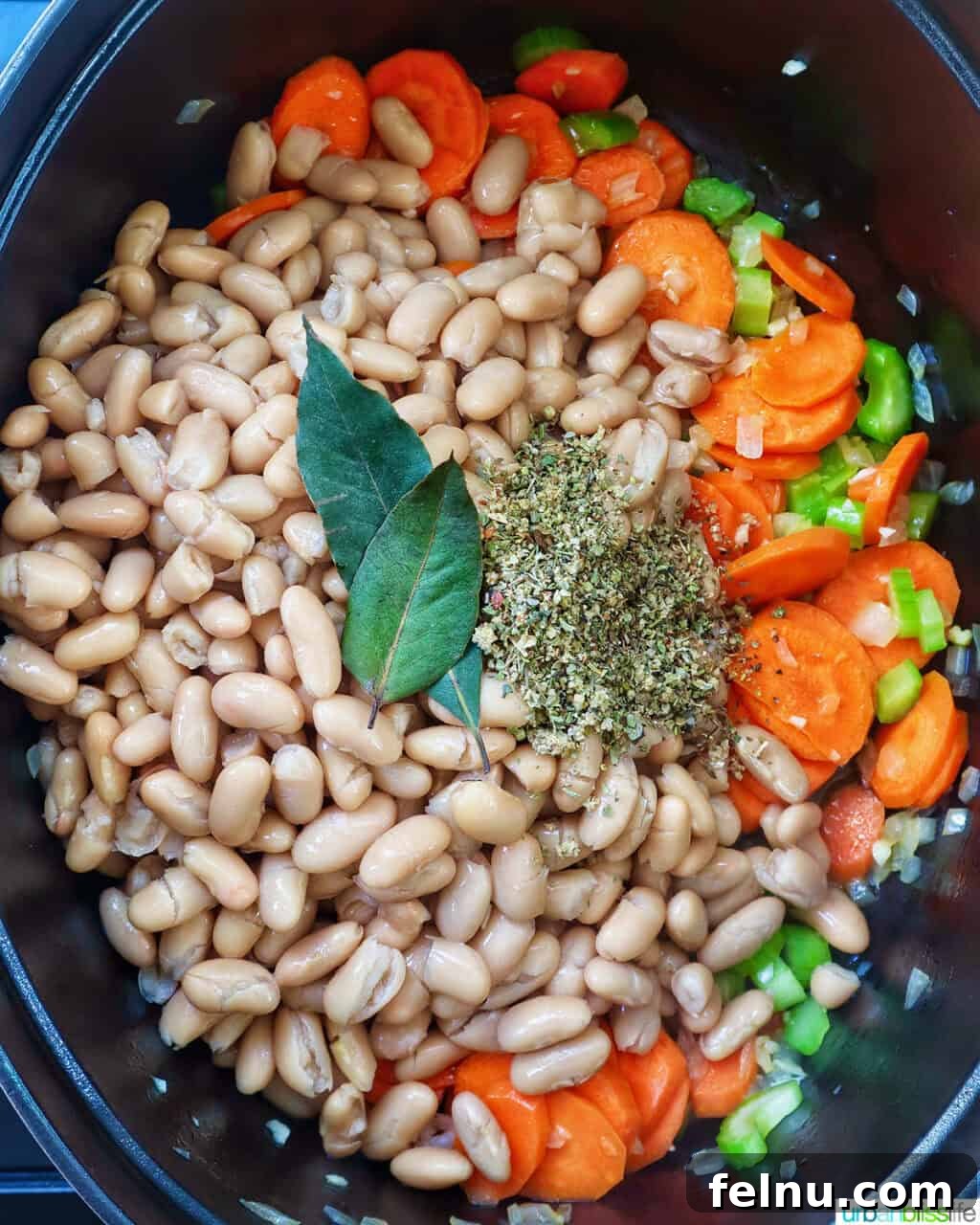 Tuscan Kale and White Bean Soup: A Hearty Italian Classic 9 Adding beans, bay leaves, and herbs to the vegetables