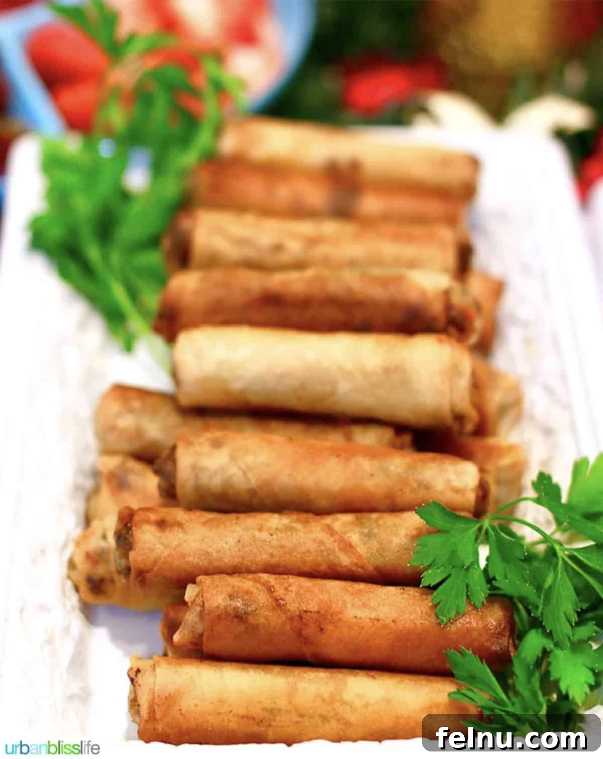 Tray of golden brown Filipino lumpia, perfectly fried and ready to serve.