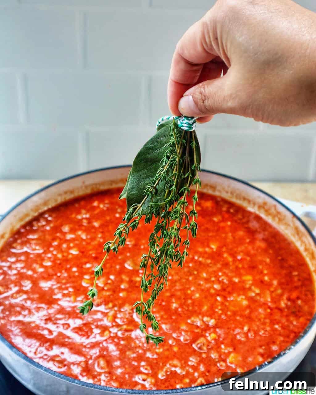 Adding herbs to lamb ragu
