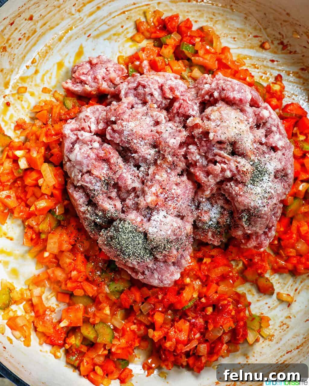Ground lamb added to pan of vegetables