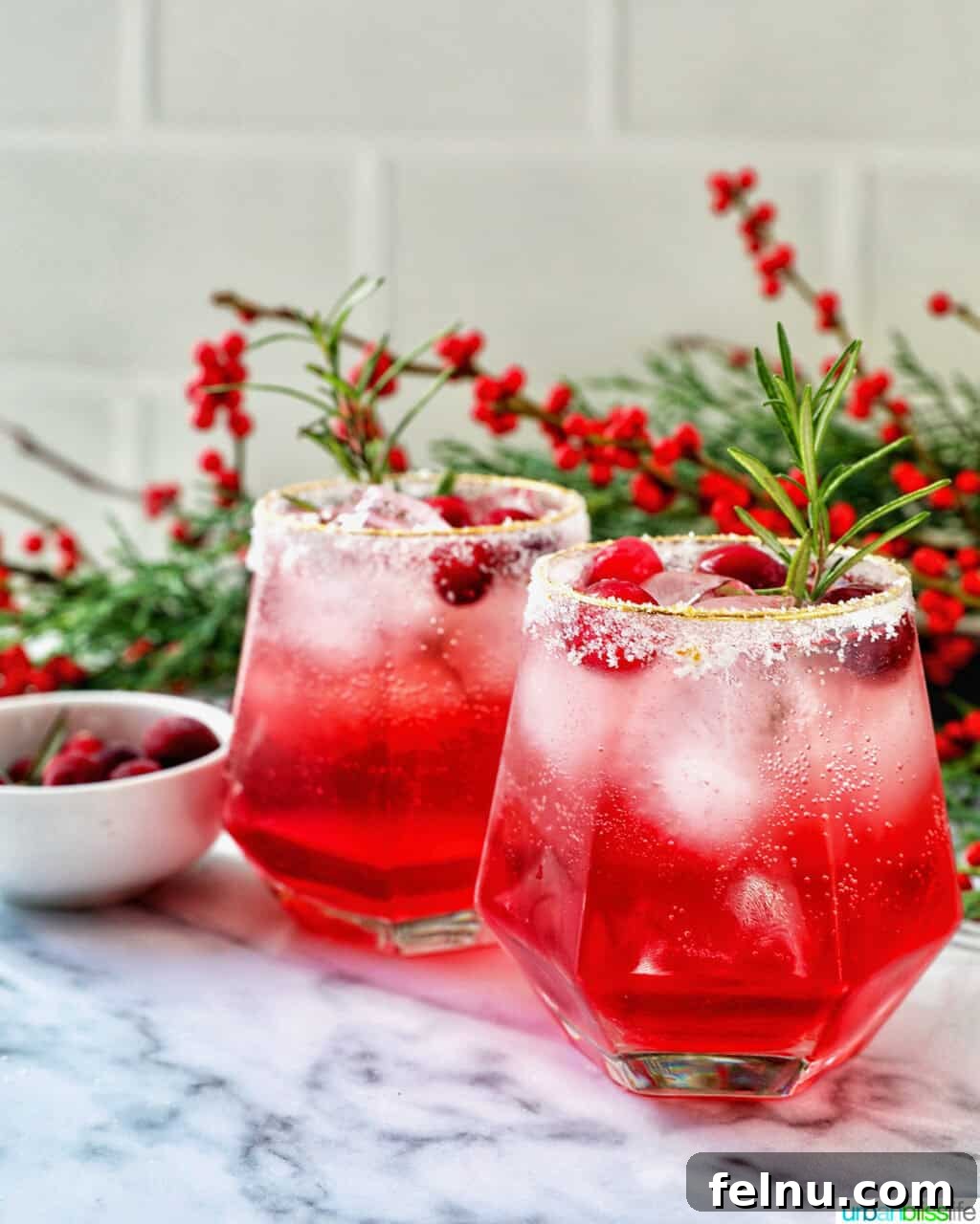 glasses of cranberry mocktail drink with festive christmas decorations.
