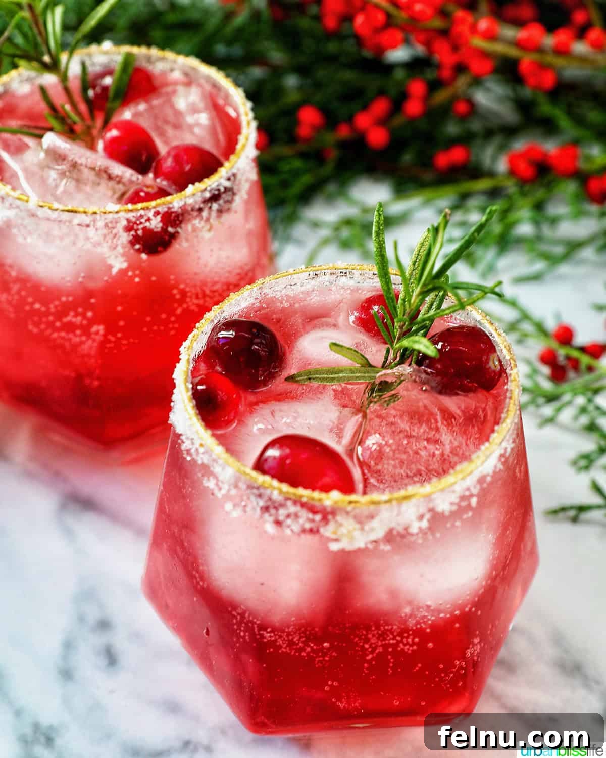 glasses of cranberry mocktail drink with festive christmas decorations.