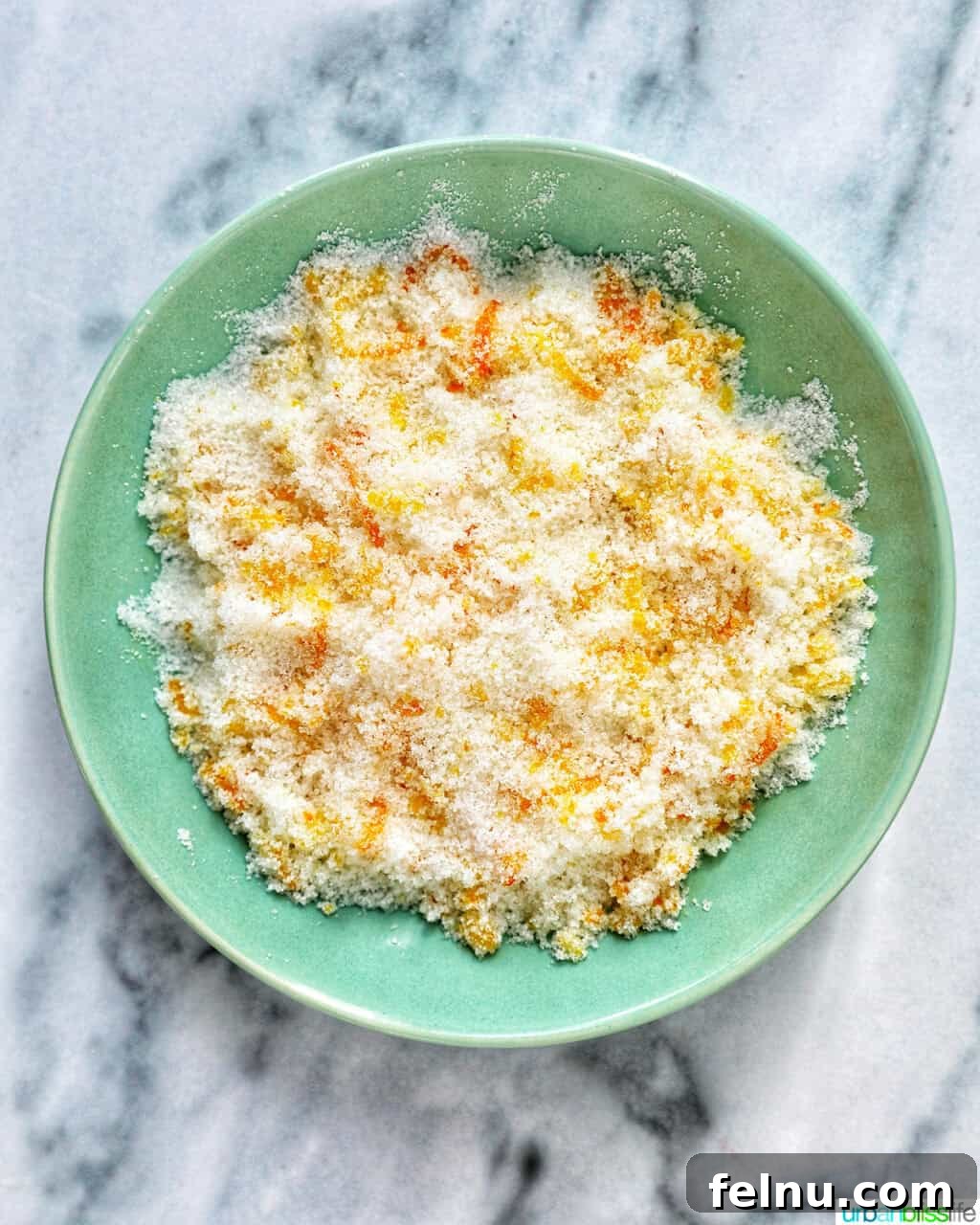 orange zest and sugar combined in a shallow bowl to make citrus sugar.