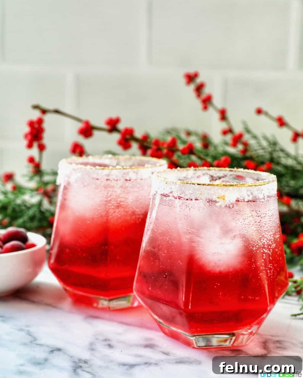 glasses of cranberry mocktail drink with festive christmas decorations.