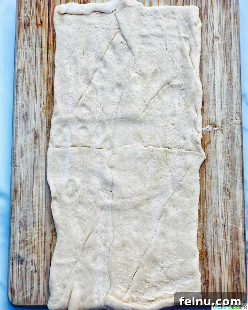 Crescent dough rolled out on a cutting board